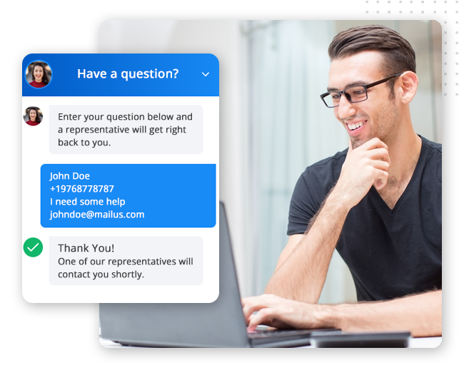 A man with glasses smiles at his laptop. On the screen, a chat window—powered by the best CRM platform—displays a customer service exchange, including a user’s contact details and confirmation that a representative will respond soon.