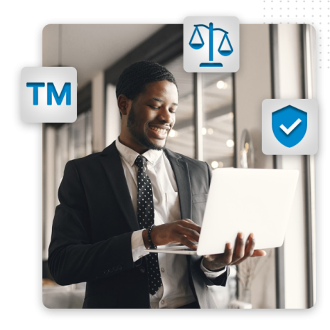 Full-Copyright--feature-img A smiling man in a suit uses a laptop in a bright office. Trademark, justice scales, and shield icons appear around him, symbolizing legal protection and professional logo design for intellectual property concepts.