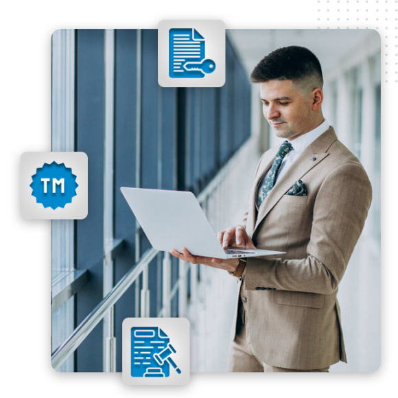 A man in a tan suit stands in a modern hallway using a laptop. Surrounding him, three blue icons symbolize legal and trademark concepts—essential elements for a graphic artist providing brand design or graphic design services.