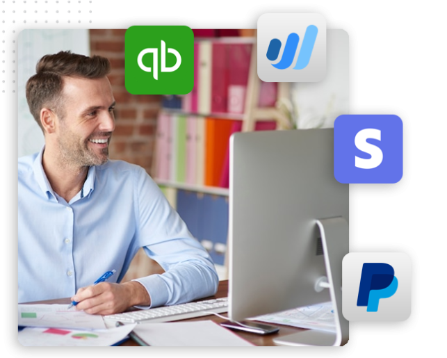 xtreme-automator-gateway-acounting-Collection-img A smiling man sits at a desk working on a computer, surrounded by logos of QuickBooks, Wave, Stripe, and PayPal, suggesting he is managing finances for an automation company or integrating a CRM platform with these payment solutions.
